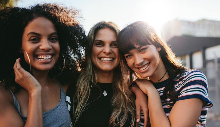 a group of smiling women in their 20s